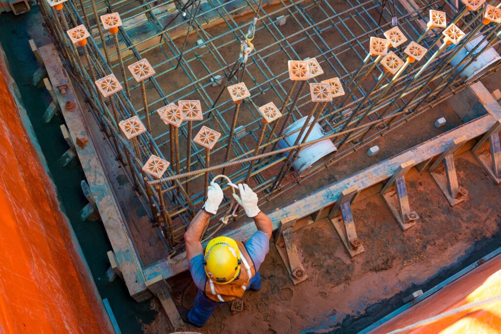 Ironworkers installing concrete rebar for a new valve box being constructed