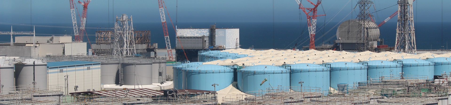 Exterior view of Fukushima work site with ocean view in background.