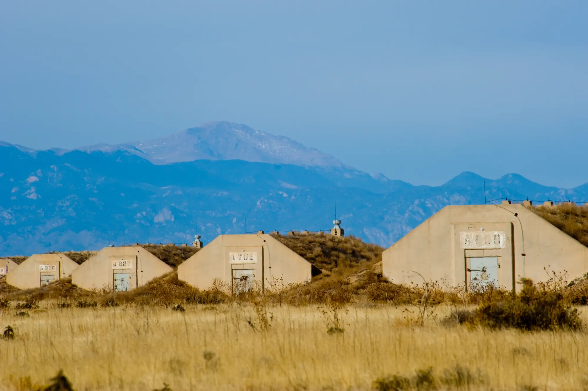 U.S. Army Pueblo Chemical Depot igloos with Pikes Peak in the background