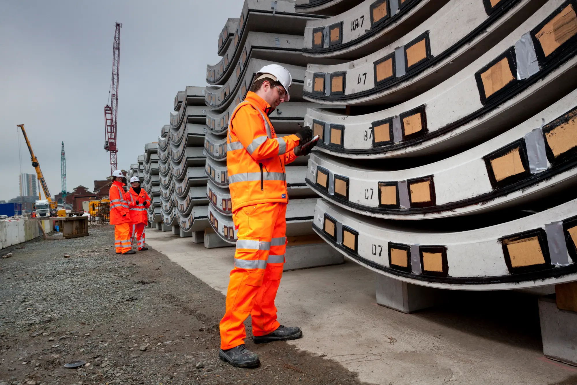 Worker inspects tunnel segments ready for installation in Crossrail's Thames tunnel