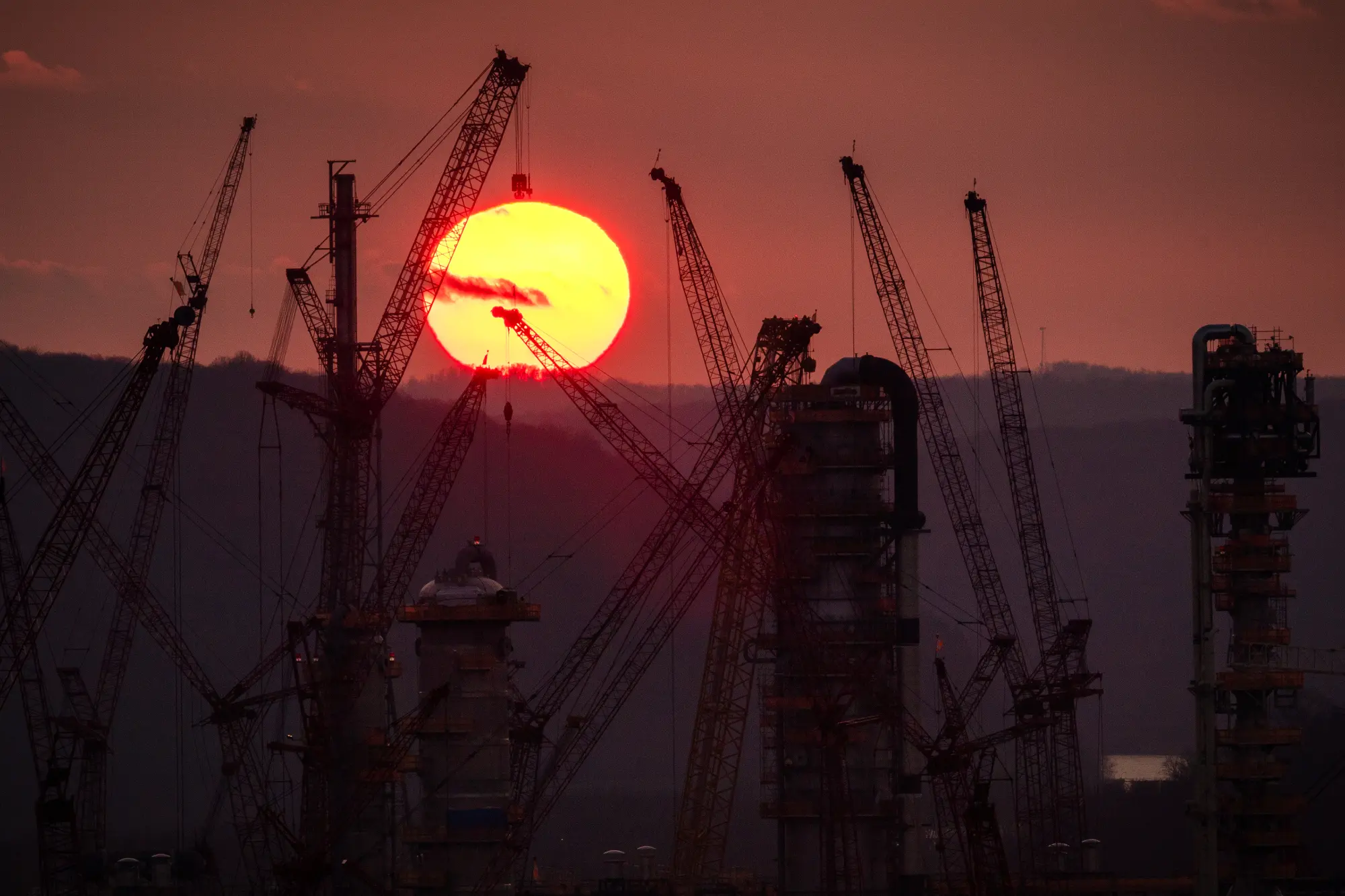 Sunrise behind construction equipment