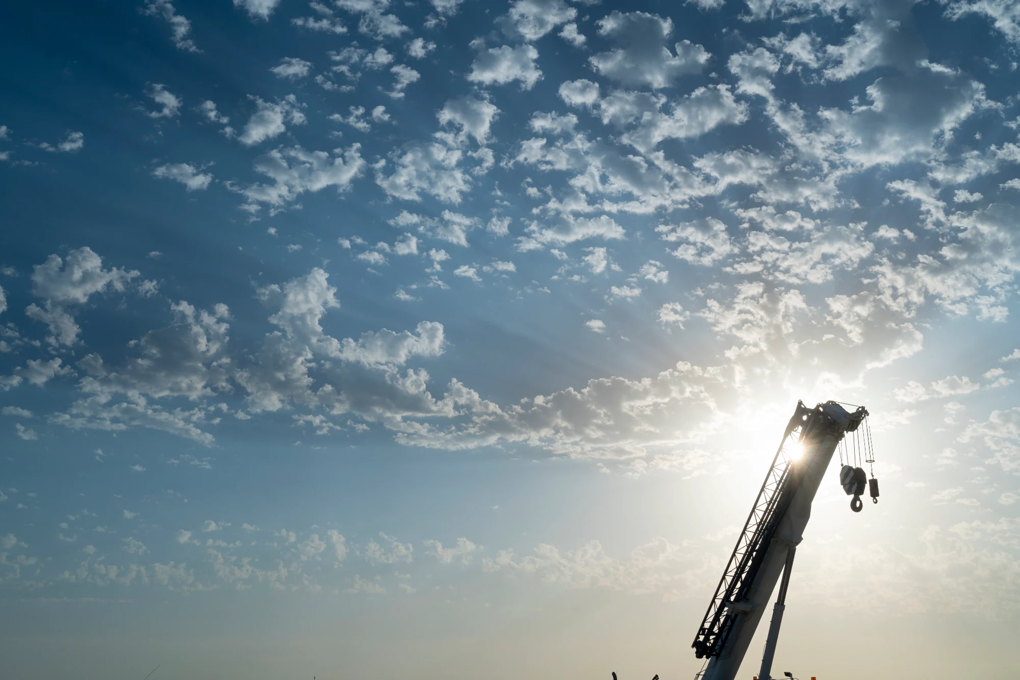 Silhouette of a crane at the project site